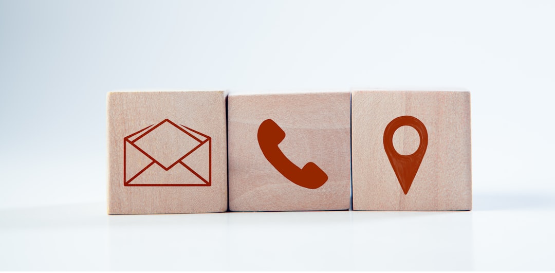 Wooden cube with contact us icon on white background. Contact us concept.
